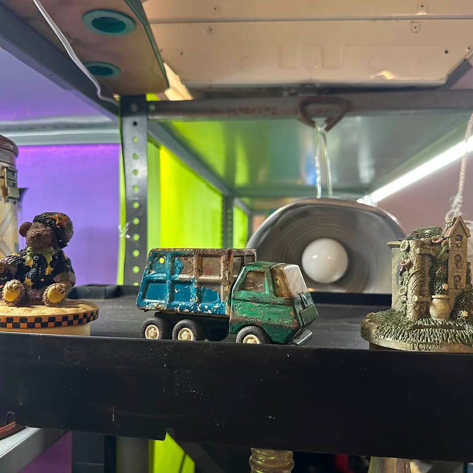 Vintage die-cast toy truck and figurines on the shelf at Jimmy's Junk
