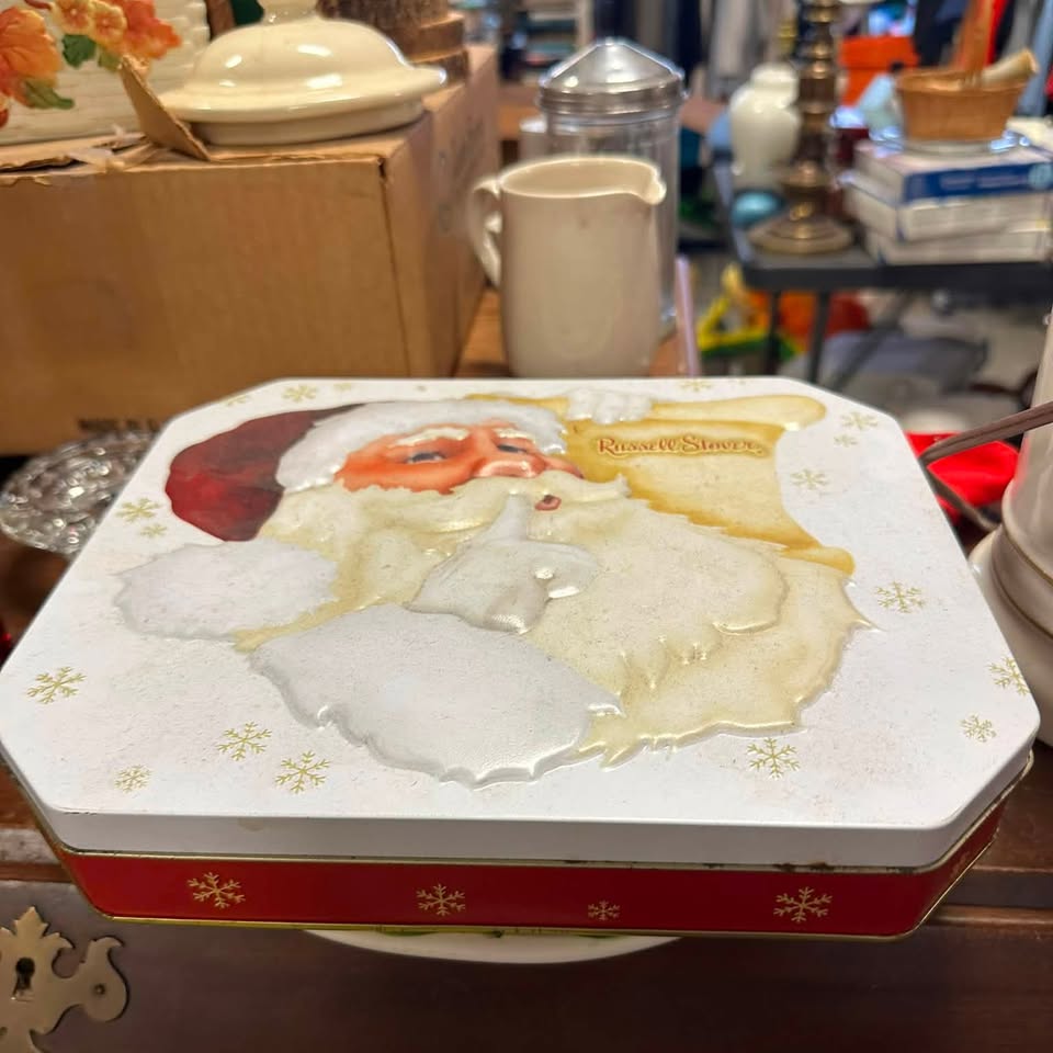 Vintage Russell Stover Santa candy tin on the collectibles floor
